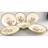 A Limoges porcelain part dessert service, decorated with flowers, leaves etc., on a blush ivory