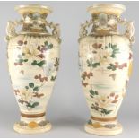 A pair of late 19th/early 20thC Japanese earthenware two handled vases, each decorated with flowers,