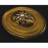 A Victorian oval bar brooch, with raised central oval design with blue enamel star, with faux seed