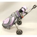 A set of Fazer ladies golf clubs, with purple bag and adjustable trolley.