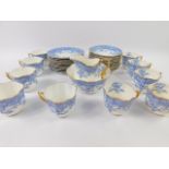 A late 19thC Wileman & Co porcelain part tea service, transfer decorated in blue with flowers,
