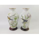 A pair of Franklin Mint porcelain vases decorated in The Meadowland Bird and The Woodland Bird