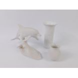 A Kaiser bisque porcelain figure group of a pair of dolphins, modelled on a wave, no 509, printed