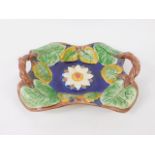 A late 19thC majolica basket, of twin handled rectangular form moulded with water lilies against a