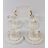 A Wedgwood late 19thC porcelain part tea service, decorated in the white with gilt handles,