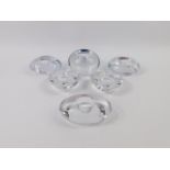 A pair of Orrefors heart shaped glass tea light holders, three oval pebble holders and a Kenneth