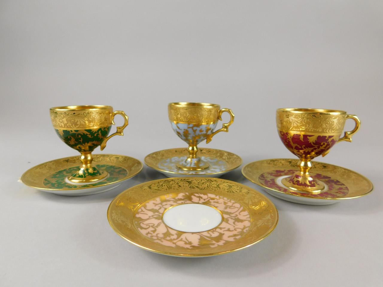 A harlequin part set of Limoges cabinet cups and saucers, each decorated in gilt and a matching