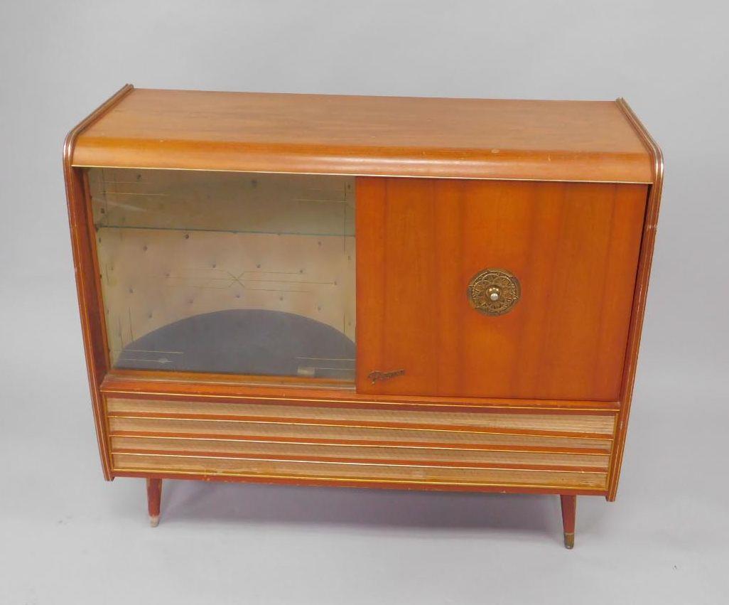 A Rema 1950's walnut cased radiogram, with a Monarch turntable, beneath ...