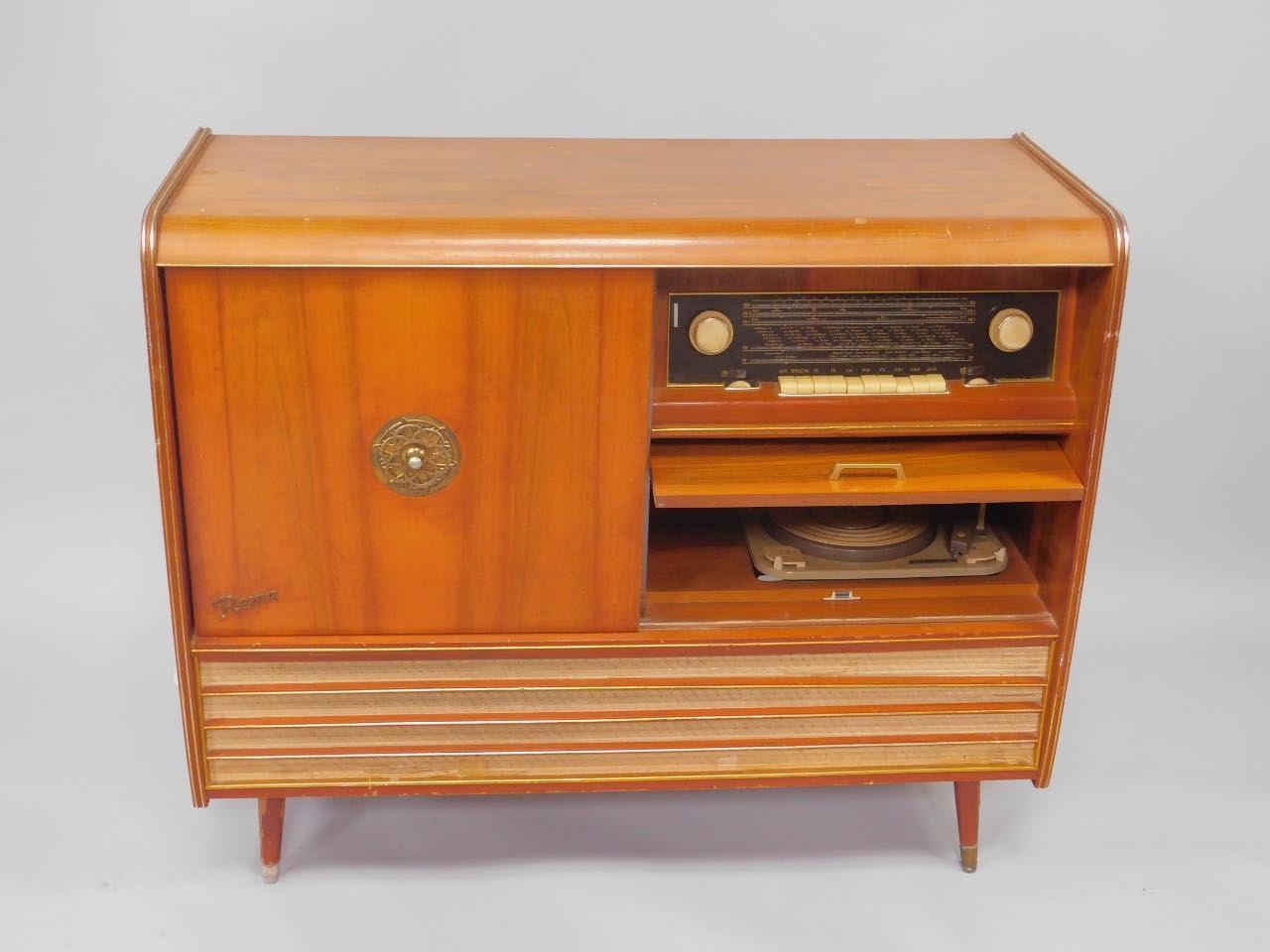 A Rema 1950's walnut cased radiogram, with a Monarch turntable, beneath ...