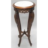 A Continental hardwood plant stand, with a circular marble top, above a pierced frieze, on leaf