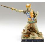 A late 19th/early 20thC majolica pottery figure of a king or knight, dressed in armour, on a