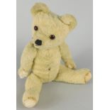 A mid 20thC blond coloured teddy bear, 18cm high (AF)