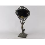 A late Art Nouveau style table mirror, the bronzed metal cast in the form of a lady holding the