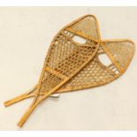 A pair of Canadian Inuit or Eskimo type snowshoes, with bentwood frames etc., 104cm long