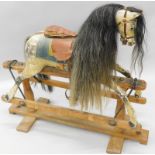 An early Tri-ang child's rocking horse, with horse hair mane, dappled grey paint, leather saddle