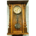 A late 19th/early 20thC Vienna walnut wall clock, with Art Nouveau style inset to the paper dial,