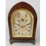 An early 20thC mahogany lancet shaped mantel clock, the arched silvered dial with subsidiary dials