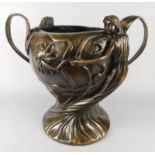 A large Art Nouveau style bronze two handled vessel, case with figures, leaves etc., 38cm high