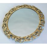 A 20thC gesso oval wall mirror, with a foliate frame, 66cm x 56cm. (AF)