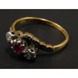 A dress ring, set with rubies and two diamonds, in an illusion set twist design, yellow metal,