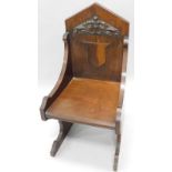 A Victorian oak ecclesiastical style throne type chair, with gothic carved back, a vacant cartouche,