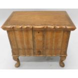 A Dutch colonial type hardwood workbox, the hinged lid enclosing a fitted interior, carved overall