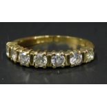 An 18ct gold diamond half hoop eternity ring, set with seven stones, in a claw setting, 2.8g all in.