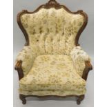 An Italian style stained beech armchair, upholstered in gold and cream fabric on cabriole legs.The