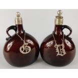 A pair of Victorian brown tinted mallet shaped claret jugs, each with silver plated stopper and