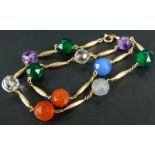 An abstract multi stone necklace, set with clear, orange, blue, green and purple beads, with