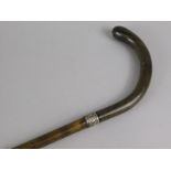 A late 19th/early 20thC walking stick, with unmarked white metal collar and horn handle