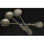 Three various Russian white coloured metal spoons, each with a hammered coin inset to the bowl,