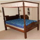 A 19thC mahogany four poster bed, with carved decoration, panelled foot and headboard, adapted