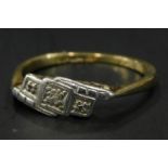 An Art Deco dress ring, set with tiny diamonds, in a white metal head, on a yellow metal band,