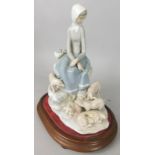 An early Lladro porcelain figure group, of a lady with piglets, impressed mark to underside, and