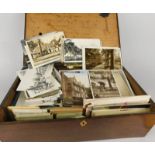 A quantity of early 20thC and later postcards, and a 19thC oak writing box (incomplete)