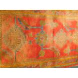 An early 20thC Turkey runner, on a red ground, 97cm x 244cm