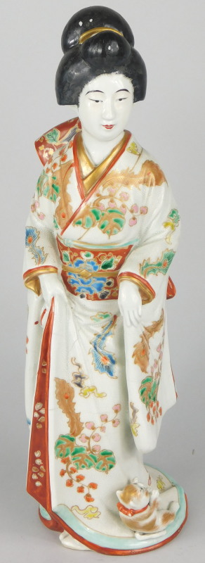 A 19thC Japanese porcelain Meiji figure, of a geisha girl and a kitten, with an elaborately