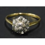 A diamond floral cluster ring, set with seven stones, each stone approx 0.1cts, on a yellow metal