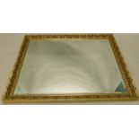 A large wooden gilt wall mirror, with a bevelled plate, 134cm x 103cm