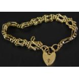 A 9ct gold gate bracelet, of two cross and three row bar design, with safety chain and padlock, 14.