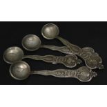 Four Russian white metal spoons, each with a different hammered coin to the bowl and with a bust