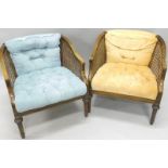 A pair of Continental beech bergere type chairs, each with a padded back and seat, one in blue