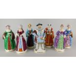 A collection of seven German porcelain figures, Henry VIII and his six wives, each on a circular