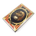 A Victorian papier mache card or cigarette case, decorated with a hound, after Sir Edwin Landseer,