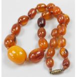 A graduated amber necklace, on orange string, many beads with markings, 36.2g all in.