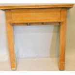 An oak fire surround, with a panelled frieze, plain supports, 135cm wide