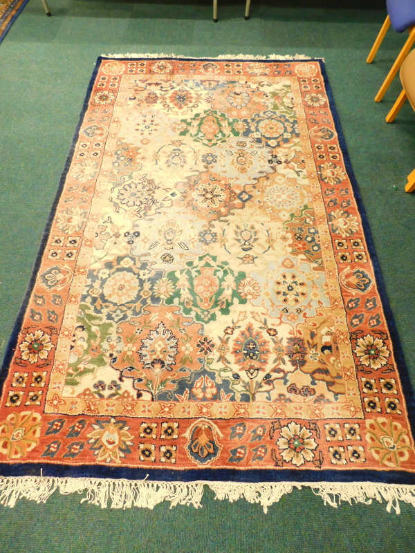 An Eastern style machine woven carpet, a Royal Palace hand made rug, in the Kirman style, 153cm x