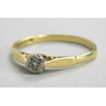 An 18ct gold dress ring, with illusion set tiny diamond, on layered shoulders, 2g all in.