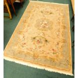 An oriental type wool rug, with a design of flowers on a beige ground, 272cm x 177cm